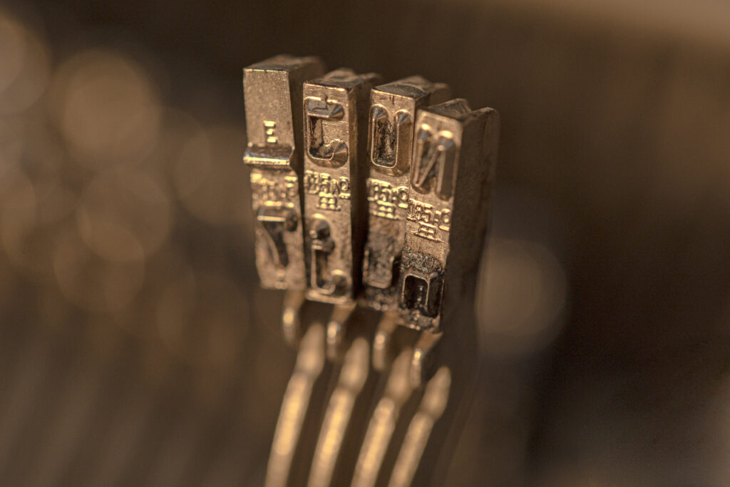 defocused metallic typesetting letters